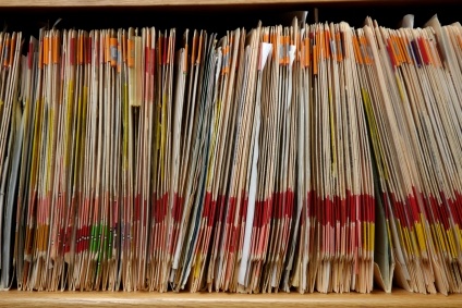 Row of medical files in a traditional office practice Row of medical files in a traditional office practice