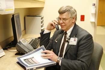 Doctor talking to a patient on the phone Doctor talking to a patient on the phone