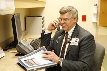Doctor talking to a patient on the phone Doctor talking to a patient on the phone